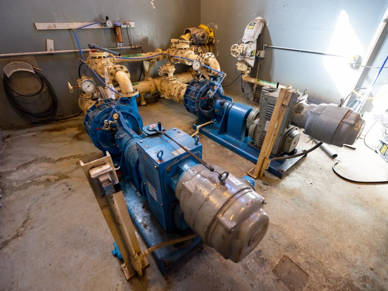 Motor-pump sets with couplings and pressure gauges in a mechanical room