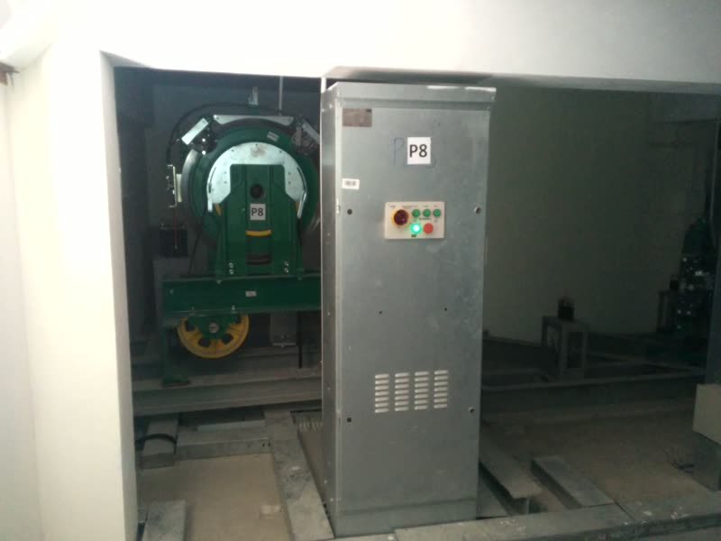 Elevator traction machine and control panel in the machine room