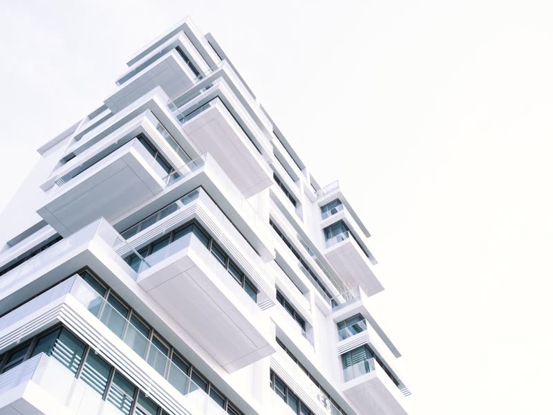 White residential tower with stacked balconies