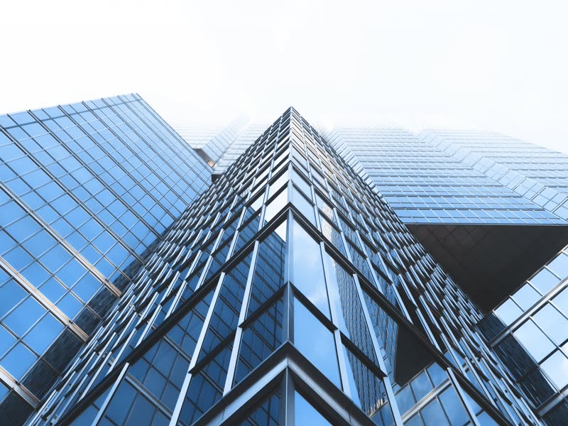 Glass facade of office towers seen from below